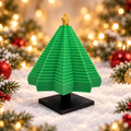Green geometric Christmas tree on black stand with gold star