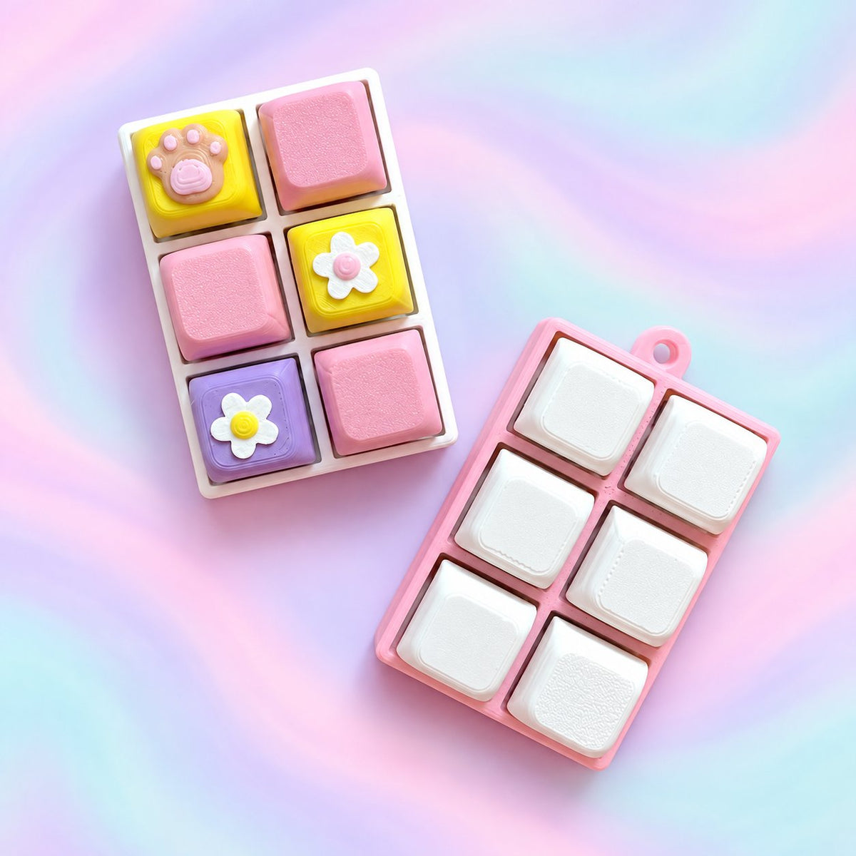 Two six-cap personalised 3D clickers on a pastel background, without chains